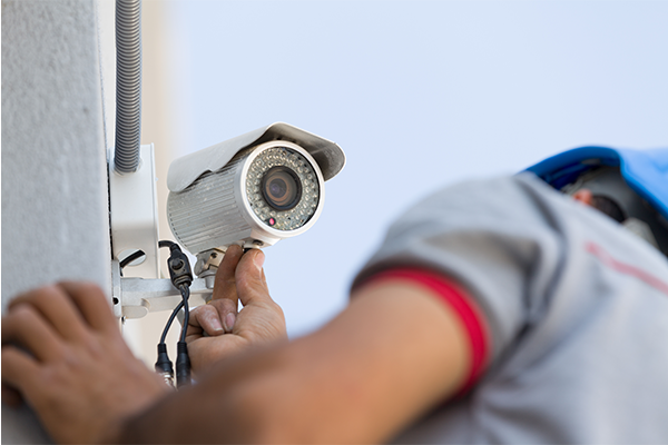 Man installing security camera