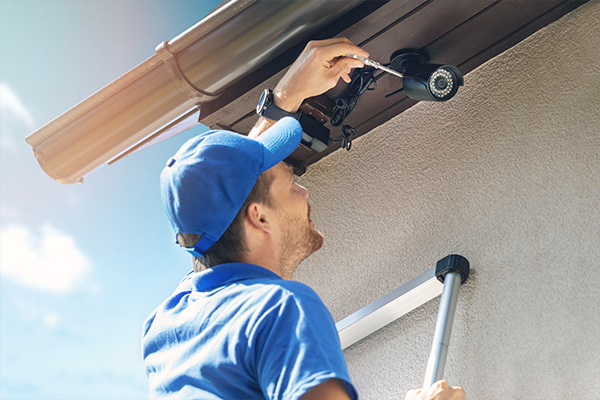 Man installing a security camera